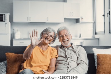 Sixty years couple, elderly parents communicates with grown up children using modern technologies makes video call, wave hands gesture of hello or goodbye sign, older generation and internet concept