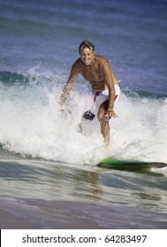 Sixty-four Year Old Man Surfing In Hawaii