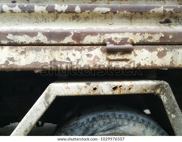 Six-wheeled dump trucks with heavy\
duty but lack of care do not wash and maintain up to rust and\
unmodified tires that seem to be cracking but are still\
usable.