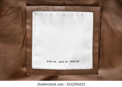 Size XL Clothing Label Closeup On Brown Fabric