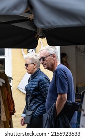 Skagen, Denmark June 7, 2022 An Older Couple Walking On The Main Shopping Street.