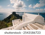 Skaros Rock at Imerovigli village with volcanic island Nea Kameni in background, Santorini, Greece. High quality photo