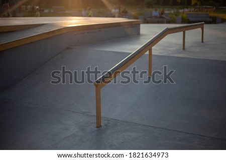 Skate area in the evening. Skate trick rail. A place for extreme tricks on the board and skates.
