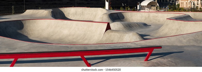 Skate park with concrete bowl, rail and pump track - Powered by Shutterstock