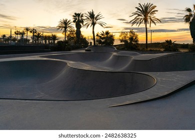 Skate park at sunrise with palm trees and orange sky - Powered by Shutterstock