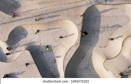 Skate Park Top View. Young People Doing Sport Riding Skaters Bicycles And Scooters. Aerial Top View. Creative Stree Photo New Concept