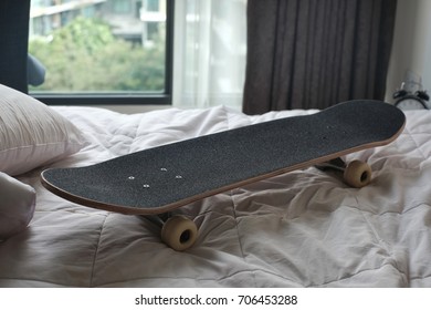 Skateboard Deck On White Messy Bed Sheet, Classic Skateboard Part - Closed Up