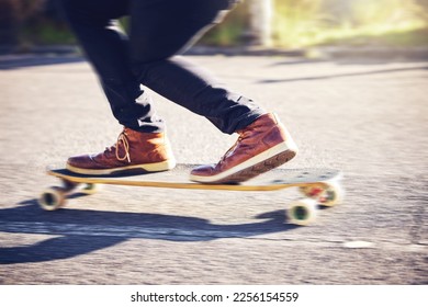 Skateboard, feet and man skating on road for fitness, exercise and wellness. Training sports, shoes and legs of male skater on board, skateboarding or riding outdoors for balance or workout on street - Powered by Shutterstock