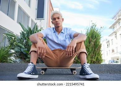 Skateboard, gen z and cool skater man in the city with a serious look outdoor. Portrait of a urban person from Mexico relax after skate training, fitness and cardio workout practice on the road