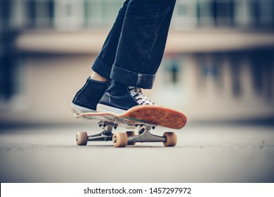 Skateboard man practices to ride on asphalt, learns tricks. - Powered by Shutterstock
