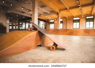 Skateboard on the mini ramp at skate park indoor with brown wooden floor. - Powered by Shutterstock