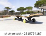 Skateboard resting on concrete surface at outdoor skate park on sunny day. sports, leisure, urban, recreation