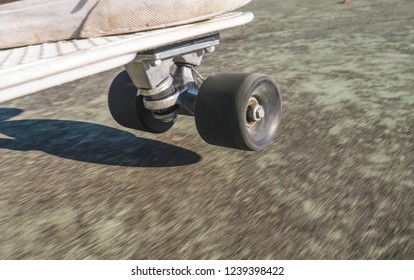 Skateboard Wheel Close Up And Shoes On White Board