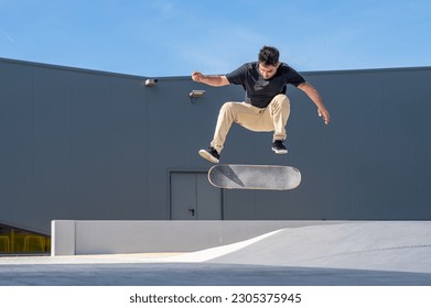 Skateboarder doing a flip trick  on a urban scene. - Powered by Shutterstock