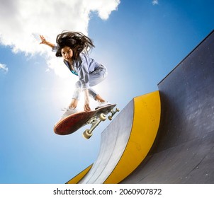 Skateboarder doing a jumping trick. Freestyle extreme sports concept - Shutterstock ID 2060907872