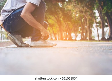 skateboarder hands tying shoelace in the sunset - Powered by Shutterstock