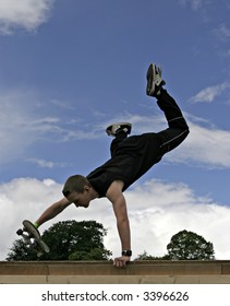 Skateboarder Handstand On Ramp - Clouds And Blue Sky