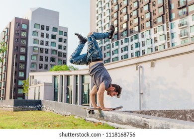 Skateboarder Handstand On Ramp On The Sunset.