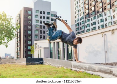 Skateboarder Handstand On Ramp On The Sunset.