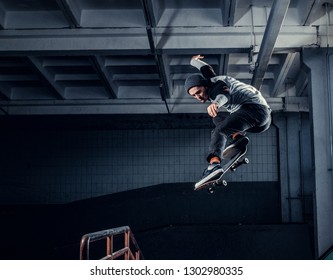 Skateboarder jumping high on mini ramp at skate park indoor. - Powered by Shutterstock