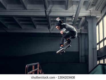 Skateboarder jumping high on mini ramp at skate park indoor. - Powered by Shutterstock