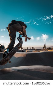 Skateboarder Jumping In Skate Park Bowl At Venice Skatepark