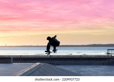 Skateboarder Jumping In A Skatepark By The Beach