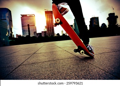 Skateboarder Legs Skateboarding Trick Ollie  At City Skate Park