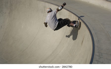 Skateboarder At McInnis County Park Skate Park In San Rafael, California Rolls On A Near Vertical Wall.