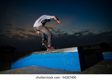 Skateboarder On A Grind At The Local Skate Park.