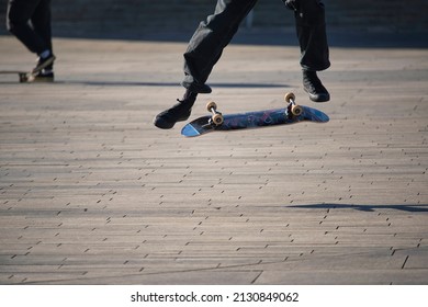 Skateboarder Performing A Kick Flip 