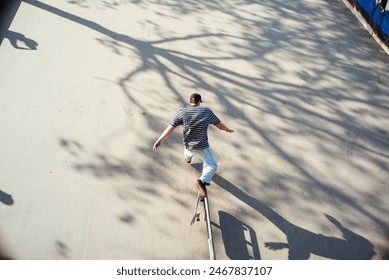 Skateboarder performing stunts at urban skate park - Powered by Shutterstock