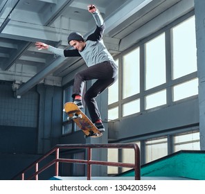 Skateboarder Performing A Trick On Mini Ramp At Skate Park Indoor.