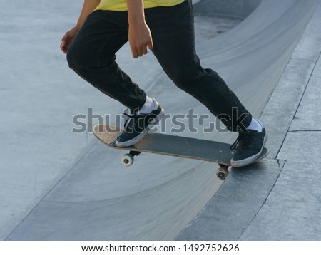 Similar – Image, Stock Photo Skateboarder performing a trick on a rail at a skatepark.