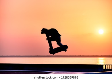 skateboarder silhouette jumping in skatepark