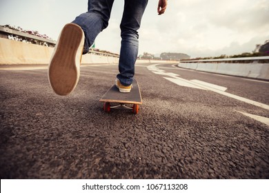 Skateboarder skateboarding  on highway road - Powered by Shutterstock