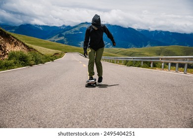 Skateboarder skateboarding on the mountain road - Powered by Shutterstock