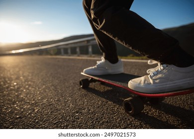 Skateboarder skateboarding on the mountain road - Powered by Shutterstock