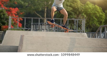 Similar – Image, Stock Photo Skateboarder performing a trick on a rail at a skatepark.