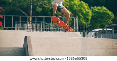 Similar – Image, Stock Photo Skateboarder performing a trick on a rail at a skatepark.