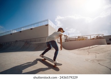 Skateboarder skateboarding at skatepark in city - Powered by Shutterstock