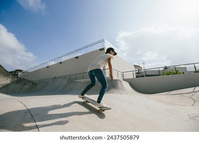 Skateboarder skateboarding at skatepark in city - Powered by Shutterstock