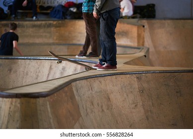 Skateboarder in skatepark indoor in winter time. Extreme concept in wooden park under the roof - Powered by Shutterstock