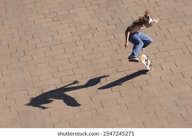 A Skateboarder Skillfully Performing a Trick while Casting a Dynamic and Engaging Shadow