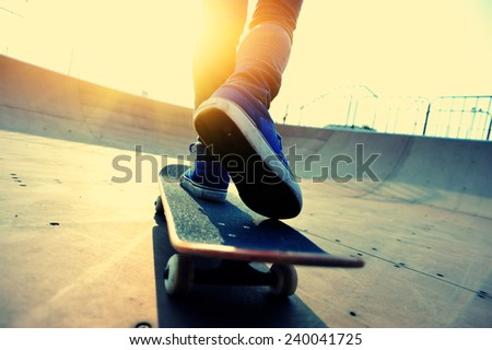 skateboarding legs at skatepark 