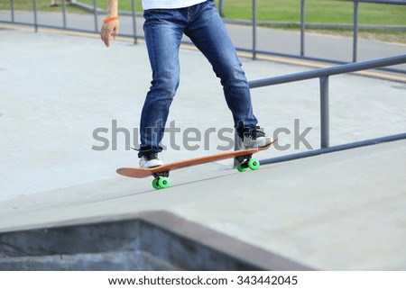 Similar – Image, Stock Photo Skateboarder performing a trick on a rail at a skatepark.