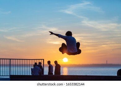 skateborder silhouette jumping facing  the sun - Powered by Shutterstock