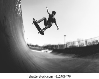 Skater boy making frontside ollie trick on the ramp - Powered by Shutterstock