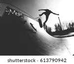 Skater doing kickflip on the ramp - black and white photo