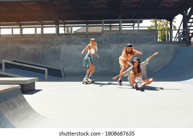 Skater Friends Riding On Skateboards At Skatepark. Hipsters In Casual Outfit Outdoor. Summer Skateboarding As Part Of Active Lifestyle. Extreme Sport As Hobby For Urban People.